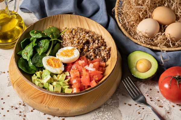 A balanced meal bowl with vegetables and grains on a table